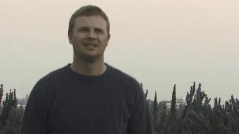 Man waling up mountain at sunset. Stock Footage 99609733