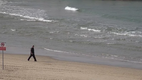 A man walk along the beach Stock Footage 100617346