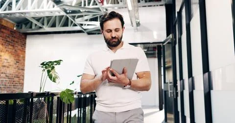 Man, walk and scroll in office with tablet, reading business sustainability Stock-Fotos