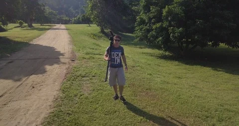 A man walk with and stop to take foto in Chiang Mai Thailand Stock Footage 100749033