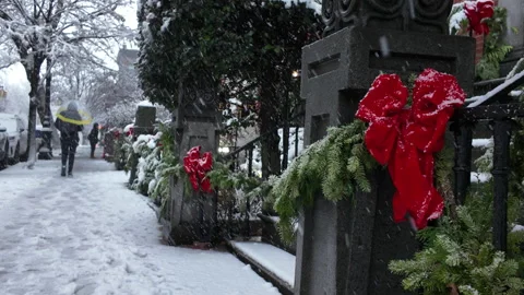 Man walk away on snow covered sidewalk with red ribbon in FG in Brooklyn Stock Footage 323635396