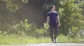 The man walk on the background of a hill. Real time capture. Wide angle 4k or 4k+ Resolution