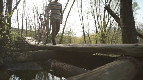 A man on a walk with a bicycle in the park Stock Footage 82864571