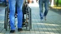 The man walk with a disabled on the street. Slow motion 4k or 4k+ Resolution