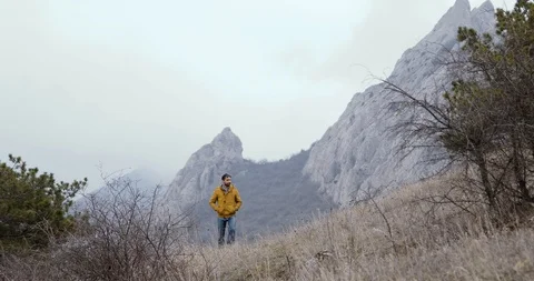 Man walk from rocks and mountains. Stock Footage 88391455