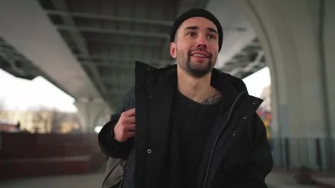 Man walk on street using navigation map. A bearded smiling man with a backpack Stock Footage 261496578