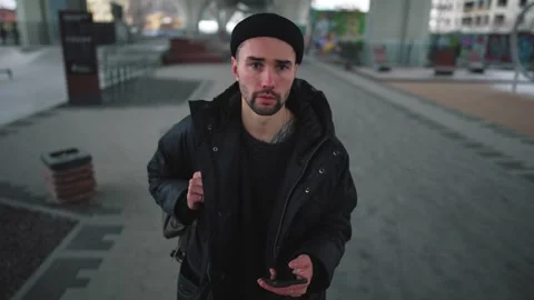 Man walk on street using navigation map. Bearded male with backpack looking at Stock Footage 261966468
