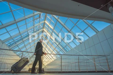 The man walk with a suitcase in the business center Stock Photos