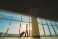 The man walk with a suitcase near panoramic windows Photo