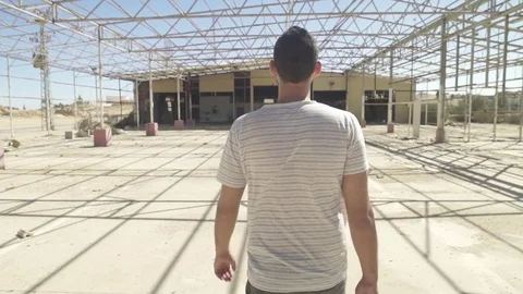 Man walking into an abandoned construction Stock Footage 81856972