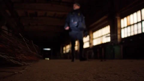 Man walking in abandoned factory Stock Footage