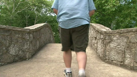Man Walking Across Bridge Stock Footage 484532
