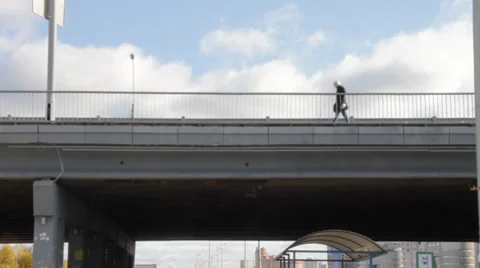 Man walking across the bridge Stockbeeldmateriaal 32372857