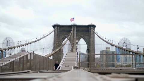 A Man walking Across The Brooklyn Bridge, New York City , Manhattan Stock Footage 109361420