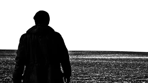 A man is walking across an endless field Stock Footage 102613858