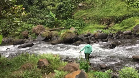 Man Walking Across Rock Stones in Rapid Mountain River Stream 库存影片 347928053