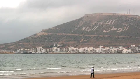Man walking on Agadir beach Stock Footage 198338974