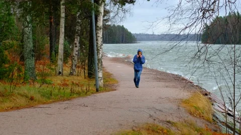 A man is walking against a strong stormwind. Stock Footage 143840052