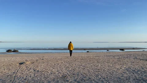 A man walking alone in the beach early morning Stock Footage 153255663