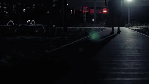 A man is walking alone in the dark on the streets Stock Footage 70005935