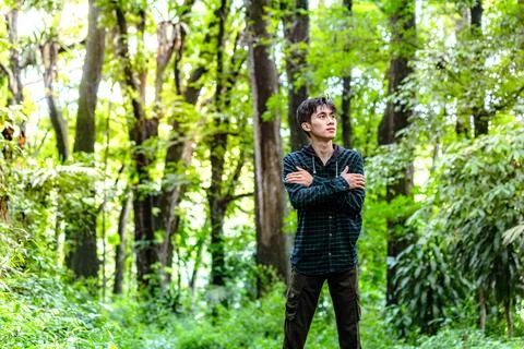 Man walking alone in deep forest and feel anxiety. Man feel nervously to wa.. Stock Photos