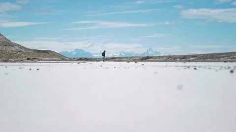 Man walking alone on the desert, distant view with heatwaves Stock Footage 255896014