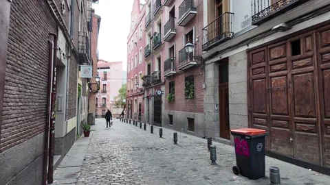 Man Walking Alone on an Empty Street in Madrid Stock Footage 295361178