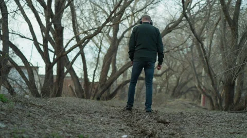 Man Walking Alone with Headphones in a Stock Video Pond5