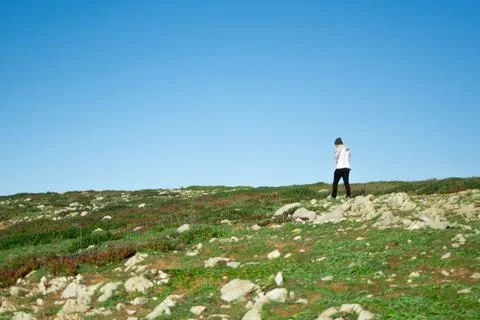 Man walking alone in the landscape Stock Photos