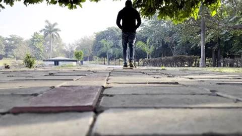 A man walking alone in the park Stock Footage 225680989