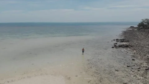 Man walking alone in the sea Stock Footage 260431814