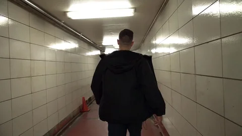 Man walking alone through a tunnel in the Chicago Underground. Vidéo 82550177
