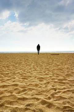Man walking alone in Varakala beach. Stock Photos