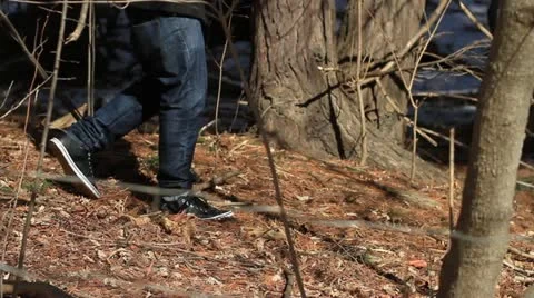 Man walking alone in the woods Stock Footage 19772085