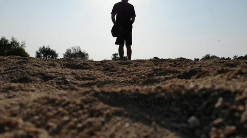 Man walking along the beach on vacation summer Stock Footage 94913952