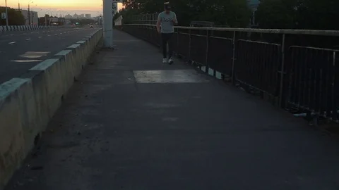 The man is walking along the bridge Stock Footage 78613139