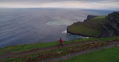 Man walking along the Cliffs of Moher Video stock 58647739