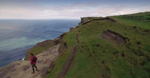 Man walking along the Cliffs of Moher Video stock 58647786