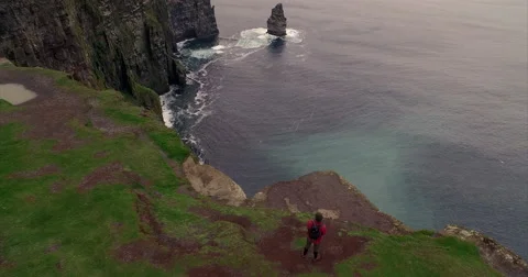 Man walking along the Cliffs of Moher Video stock 58647965