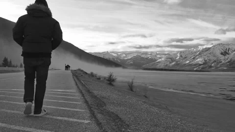 Man Walking Along a Highway in Winter Stock Footage 290789480