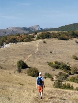 Man walking along a mountain path Foto stock