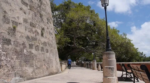 Man walking along  Paseo de la Princesa baywalk - Old San Juan Stock Footage 41818939