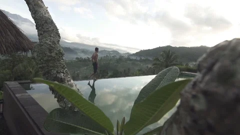Man Walking Along Pool in Bali Slow Motion Stock Footage 106152157