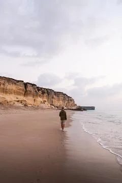 Man walking along pristine oman beach enjoying coastal lifestyle Stock Photos