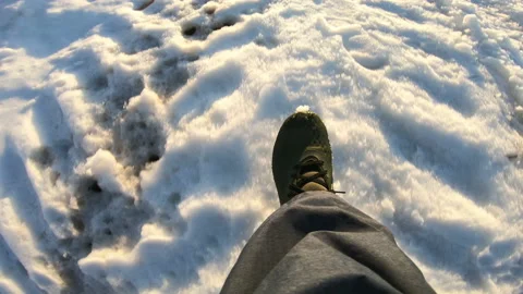 The man is walking along the road. Legs . Snow. Winter shoes . 動画素材 88663689