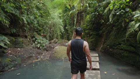 Man Walking Along a Stone Path Across a Natural Pool Ulu Petanu Stockbeeldmateriaal 347861283