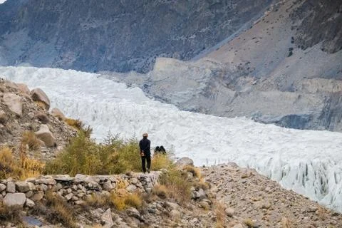 A man walking along the track to see Passu glacier. Stock Photos