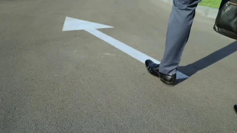 Man walking along white arrow, person choosing own life path, going right way Stock Footage 93505702