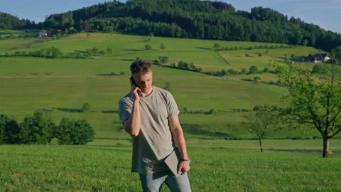 Man Walking and Calling Outdoors in Scenic Landscape 库存影片 339033780
