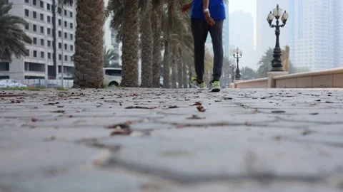 Man walking and coming in a paved footpath closeup  Stock Footage 160569734